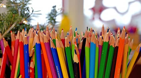 Źródło: Pixabay. Kredki ustawione pionowo, w tle okno